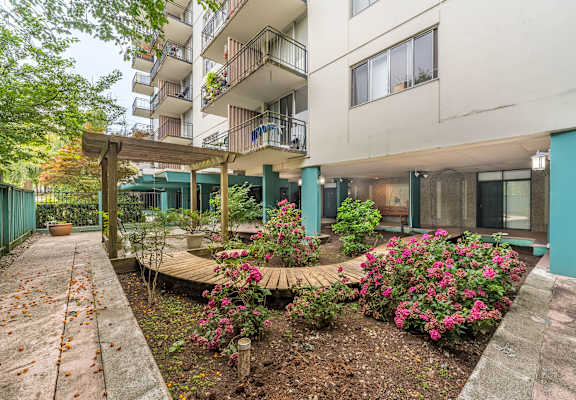 A building with a garden in front of it.