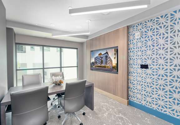a conference room with a table and chairs at Vista Brooklynn Apartments, Florida