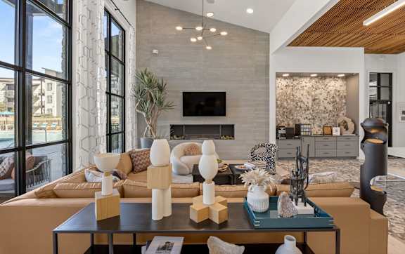 A modern living room with a fireplace and a large window. at Bridge at Tech Crossing, Austin, Texas