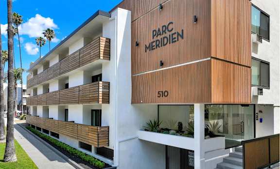 A modern building with the name "PARC MERIDIEN" on the side.