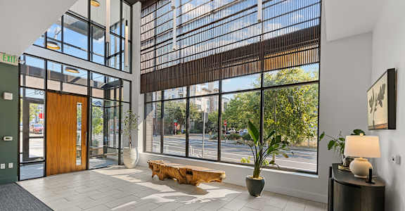 a lobby with a large window and a wooden bench