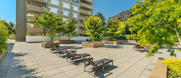 A sunny day at the outdoor seating area of a modern apartment complex.