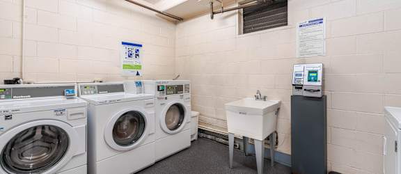 A laundry room with washers and dryers.