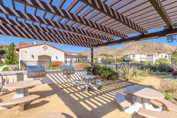 a patio with tables and chairs and a house in the background  at Mission Hills, Camarillo, CA
