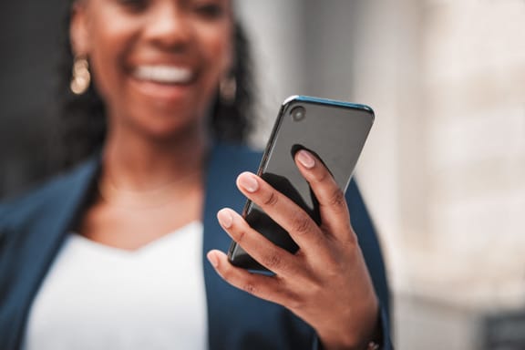 a man holding a cell phone in his hand with a notification icon on the screen
