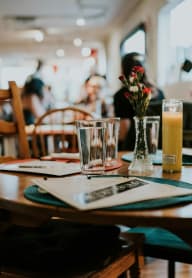 a table at a restaurant with a glass of beer on it at University Park, California