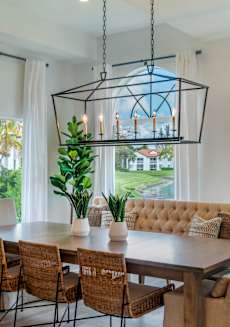a dining room with a table and chairs and a large window at The Villas at Ibis Landing, Parkland