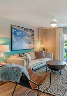 a living room with a couch and a table and a window at The Villas at Ibis Landing, Parkland, 33067
