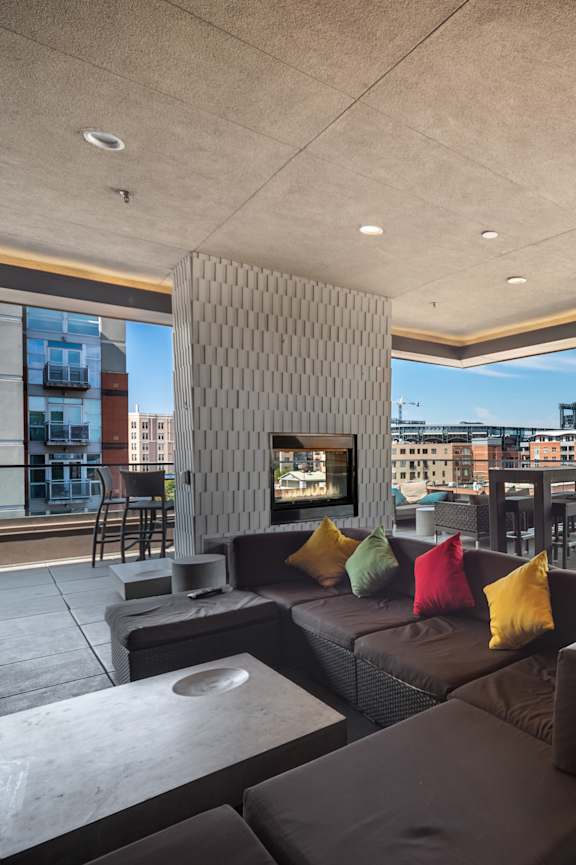A modern outdoor seating area with a view of the city.