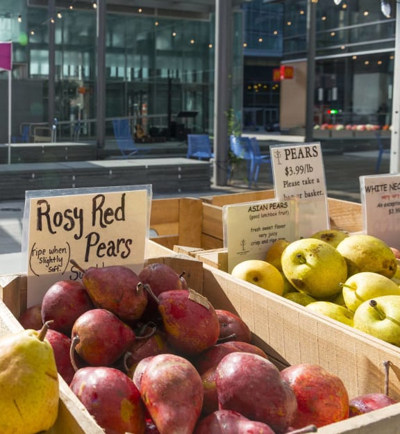 a display of apples and pears for sale at a fruit stand