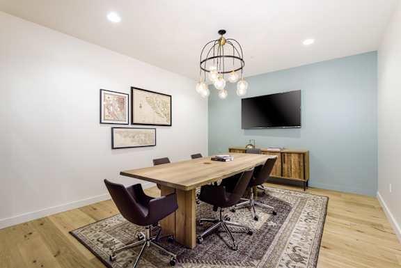 a conference room with a wooden table and chairs and a television  at Mission Hills, Camarillo, 93012