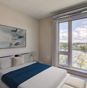 A Bedroom with a View of the City at Peregrine Apartments, Minneapolis