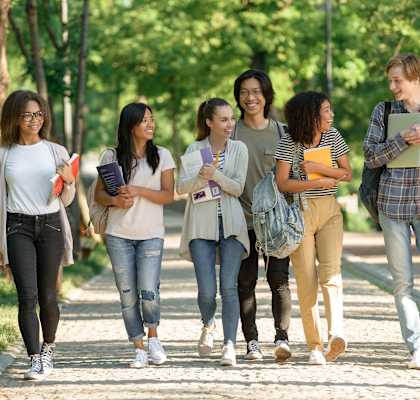 A group of students walking together on a pathway. at Cedar Park Apartments, Chico, 95926