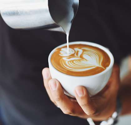 a man holding a cup of coffee