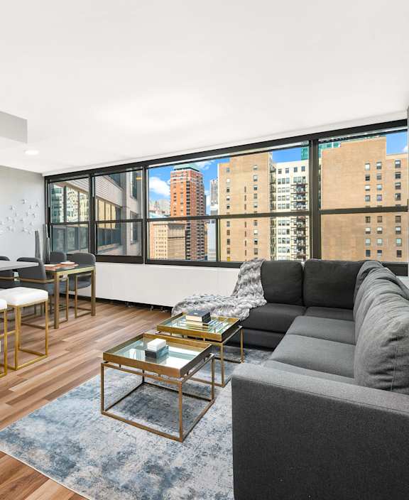Airy apartment interior with open kitchen and city skyline at Eleven Thirty Apartments, Chicago