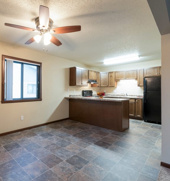 Bismarck, ND Newgate |the view of a kitchen and living room with a ceiling fan