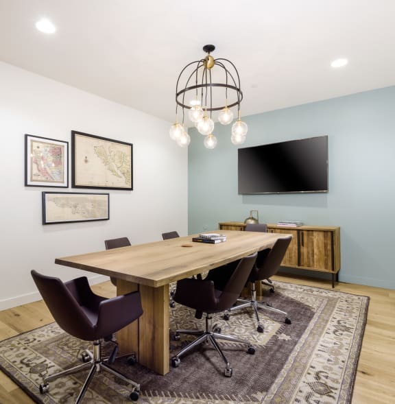 a conference room with a wooden table and chairs and a television  at Mission Hills, California, 93012