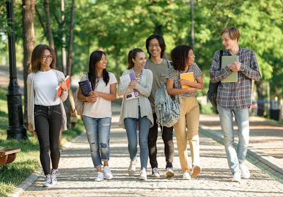 A group of students walking together on a pathway.at Redwood Cove Apartments, Chico California
