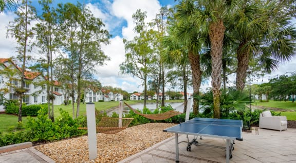 the patio has a ping pong table and a hammock at The Villas at Ibis Landing, Florida, 33067