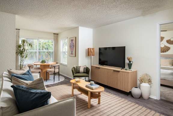 A modern kitchen with a stainless steel refrigerator and white cabinets.at The Lucille Apartments, Stuart, FL 34996