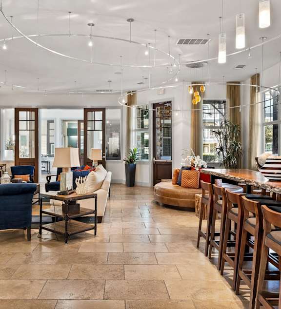 A modern living room with a grey couch and a wooden floor. at The Royce at 8100, Austin, TX, 78729