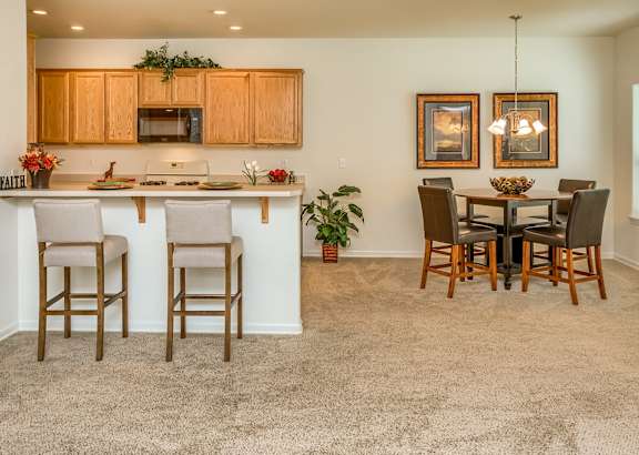 an open kitchen and dining area with a dining table and chairs