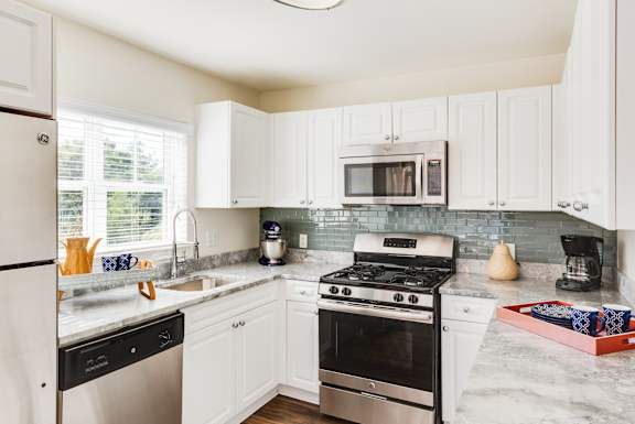 A kitchen with a black fridge and stove.