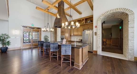 A modern kitchen and dining area with a pool table.