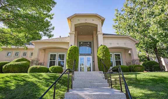 A house with a staircase leading to the front door.