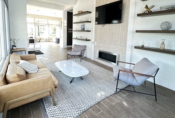 a living room with a couch and a table and a television at The Bryant Apartments at Yorba Linda, Yorba Linda, CA