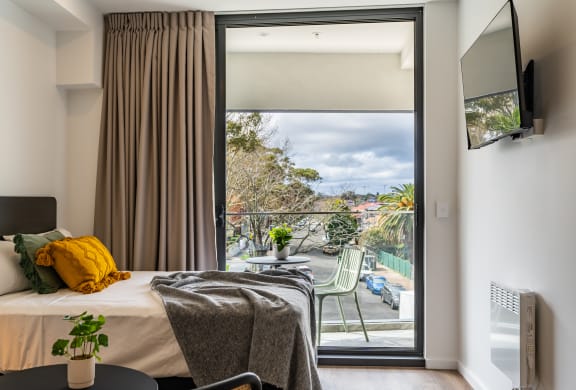 a hotel room with a bed and a balcony