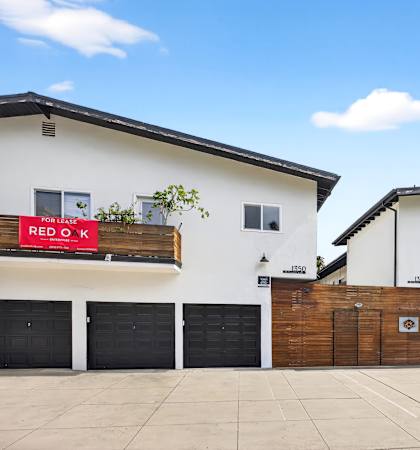 A white building with a red sign that says "RED OX" on it.