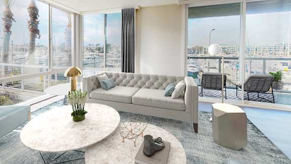 A modern living room with a large window overlooking a marina.