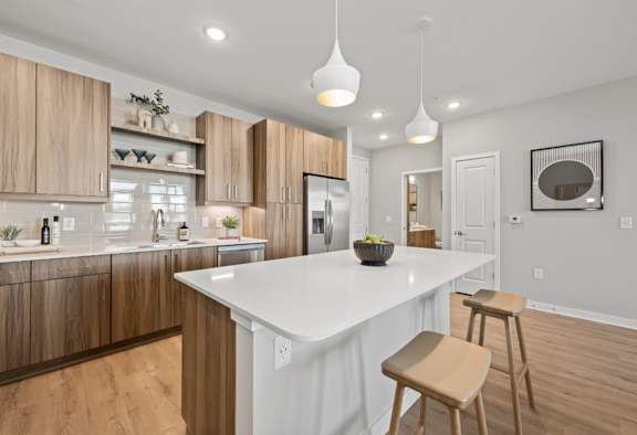 A modern kitchen with wooden cabinets and stainless steel appliances.