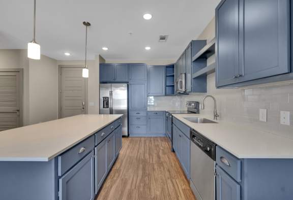 A modern kitchen with wooden cabinets and stainless steel appliances.