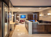 Thumbnail 6 of 9 - A reception area with a woman sitting behind the desk at Residences Providence, Providence, RI 2903
