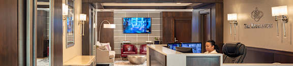 A reception area with a woman sitting behind the desk at Residences Providence, Providence, RI 2903
