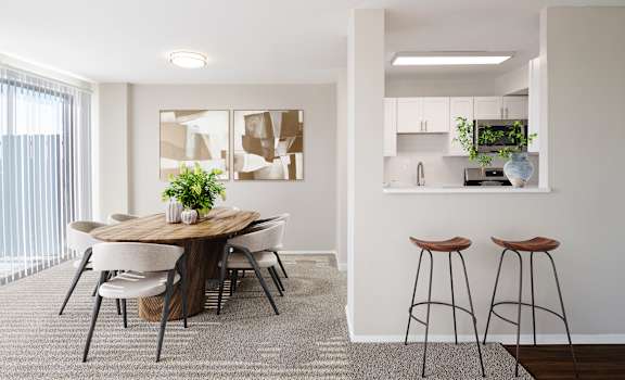 a dining room with a table and chairs and a kitchen