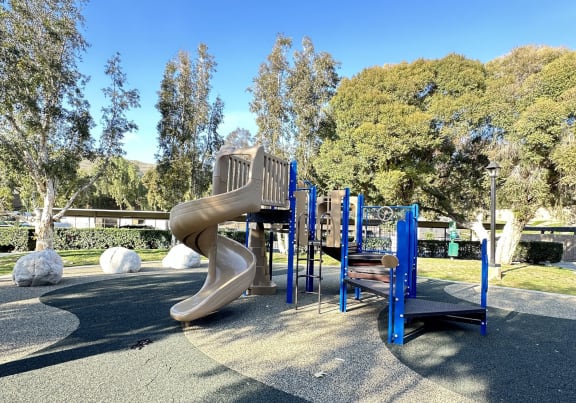 a slide at a playground at a park at The Bryant Apartments at Yorba Linda, Yorba Linda, 92887
