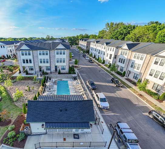 an aerial view of an apartment complex with a swimming pool