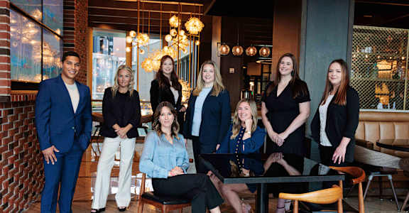 A group of people are posing for a photo in a restaurant.