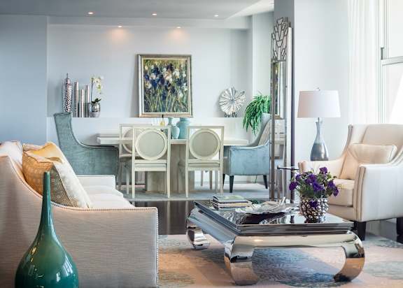 A living room with a white couch, a green vase, and a coffee table at Residences Providence, Providence, Rhode Island