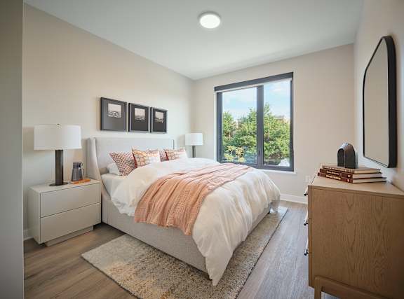 a bedroom with a bed and a window