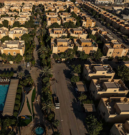 A bird's eye view of a residential area with a swimming pool.