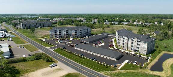 an aerial view of several apartment buildings and a highway  at Timber Ridge, Forest Lake, 55025