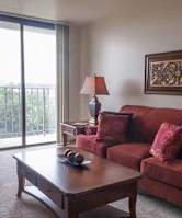 A living room with a red couch, a brown coffee table, and a lamp at Independence Place Apartments, Parma Heights, 44130
