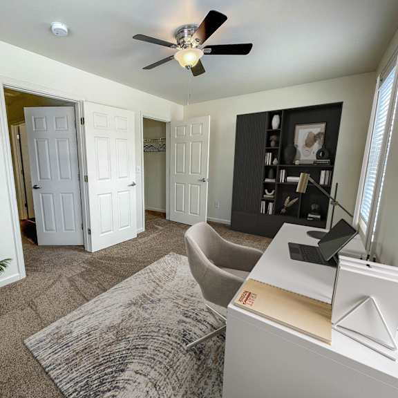 a bedroom with a bed and a ceiling fan