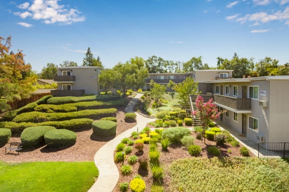 an aerial view of an apartment complex with a manicured garden