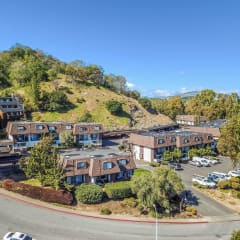 aerial view of apartment buildings and hillside