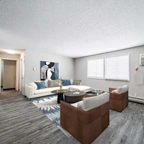 A living room with a white couch and a brown coffee table at The Ridges Apartments, Des Moines, Iowa